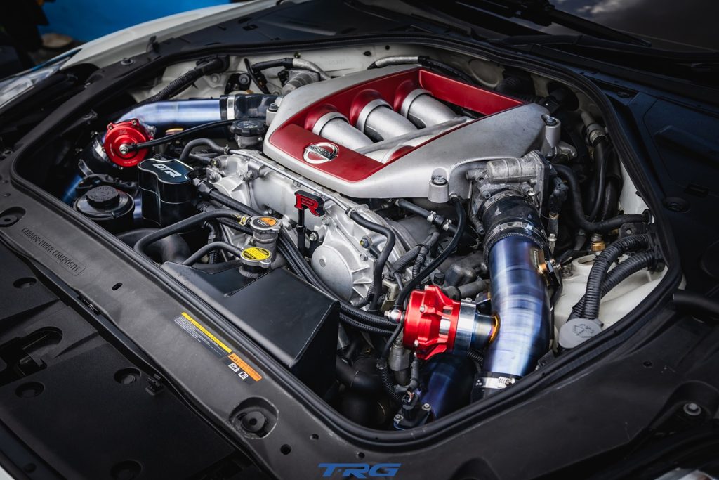 Nissan GT-R VR38DETT engine bay with aftermarket turbo piping at TopRacing Garage