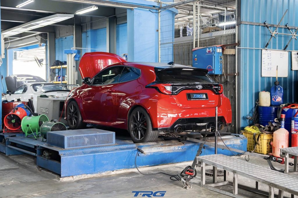 Car strapped to the chassis dyno at TopRacing Garage