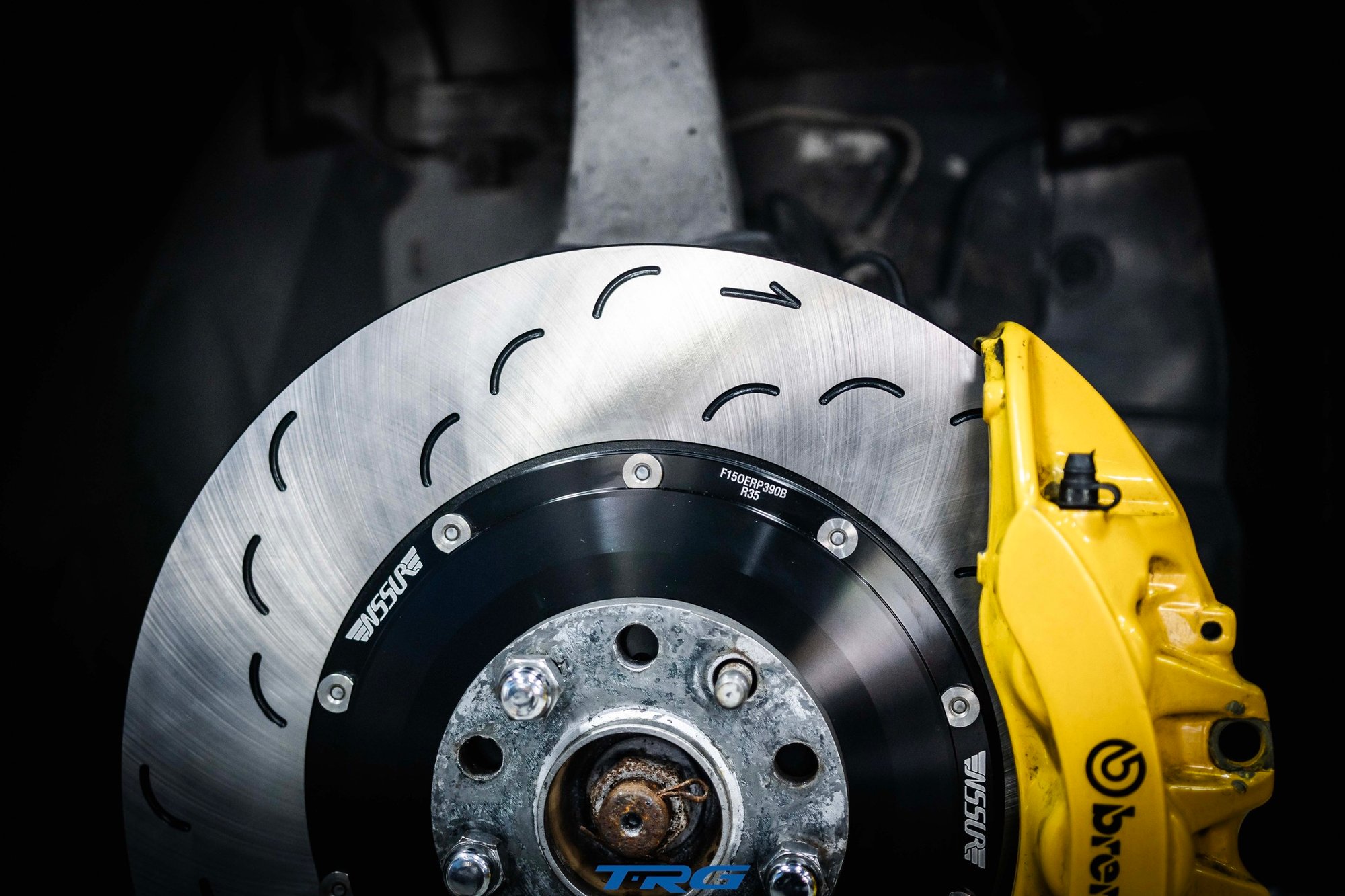 Neotech front brake disc on the car, slot pattern and part code against the Brembo caliper