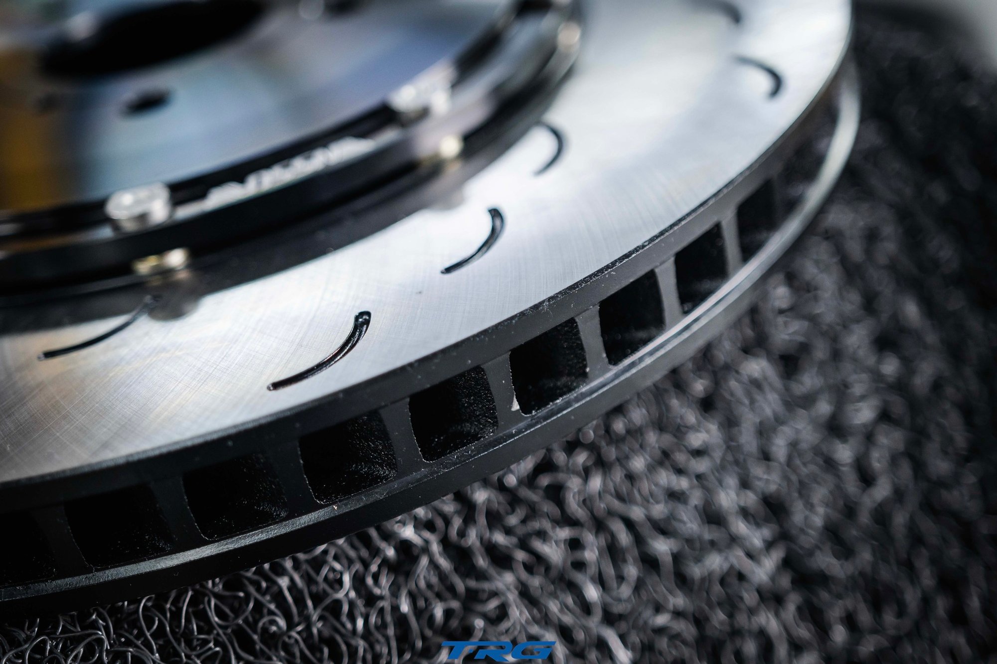 Edge on macro of a Neotech brake disc showing the ventilation vanes and the ends of the curved slots