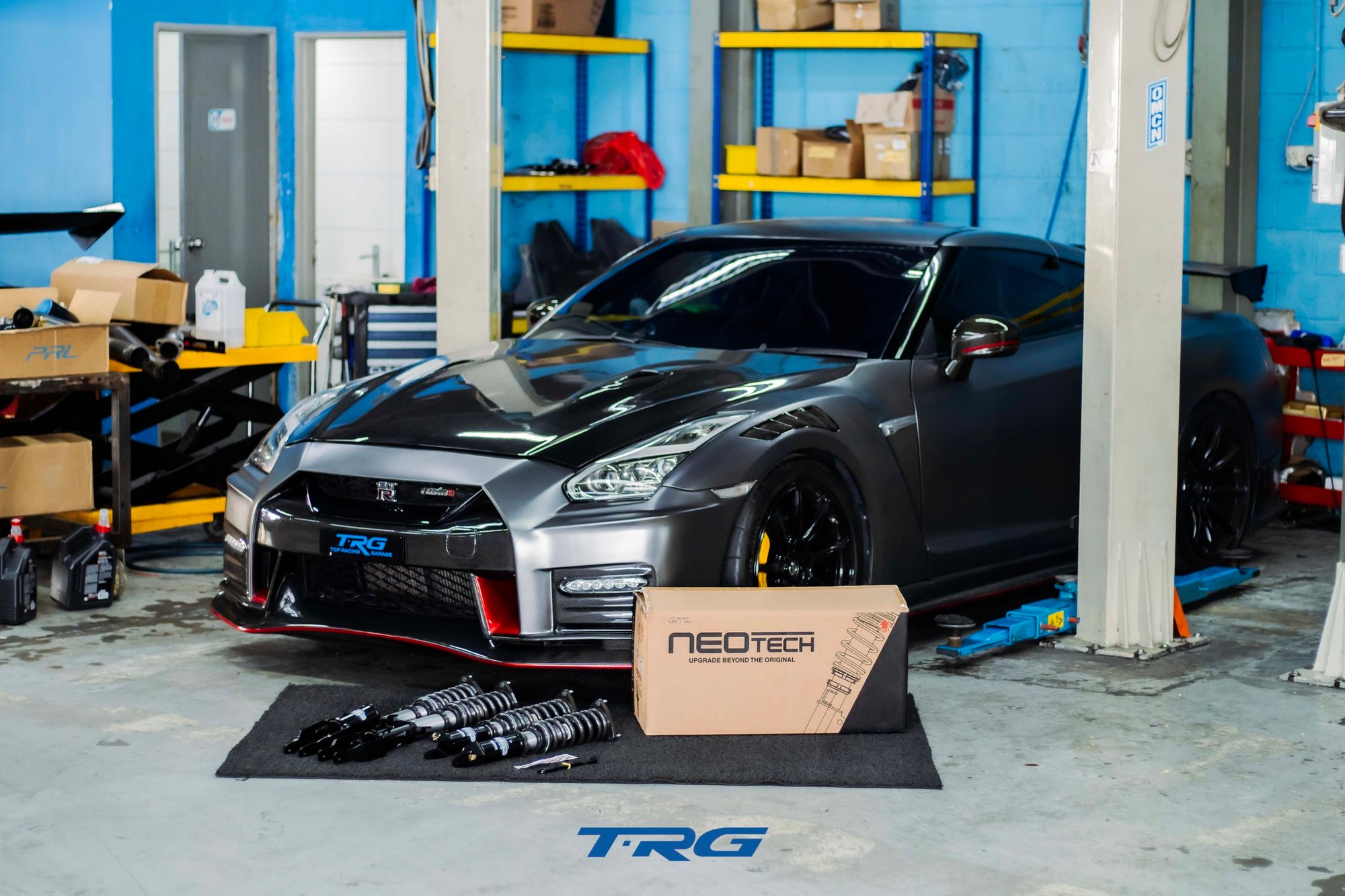 R35 GT-R in the TRG workshop with all four assembled Neotech units and a Neotech carton