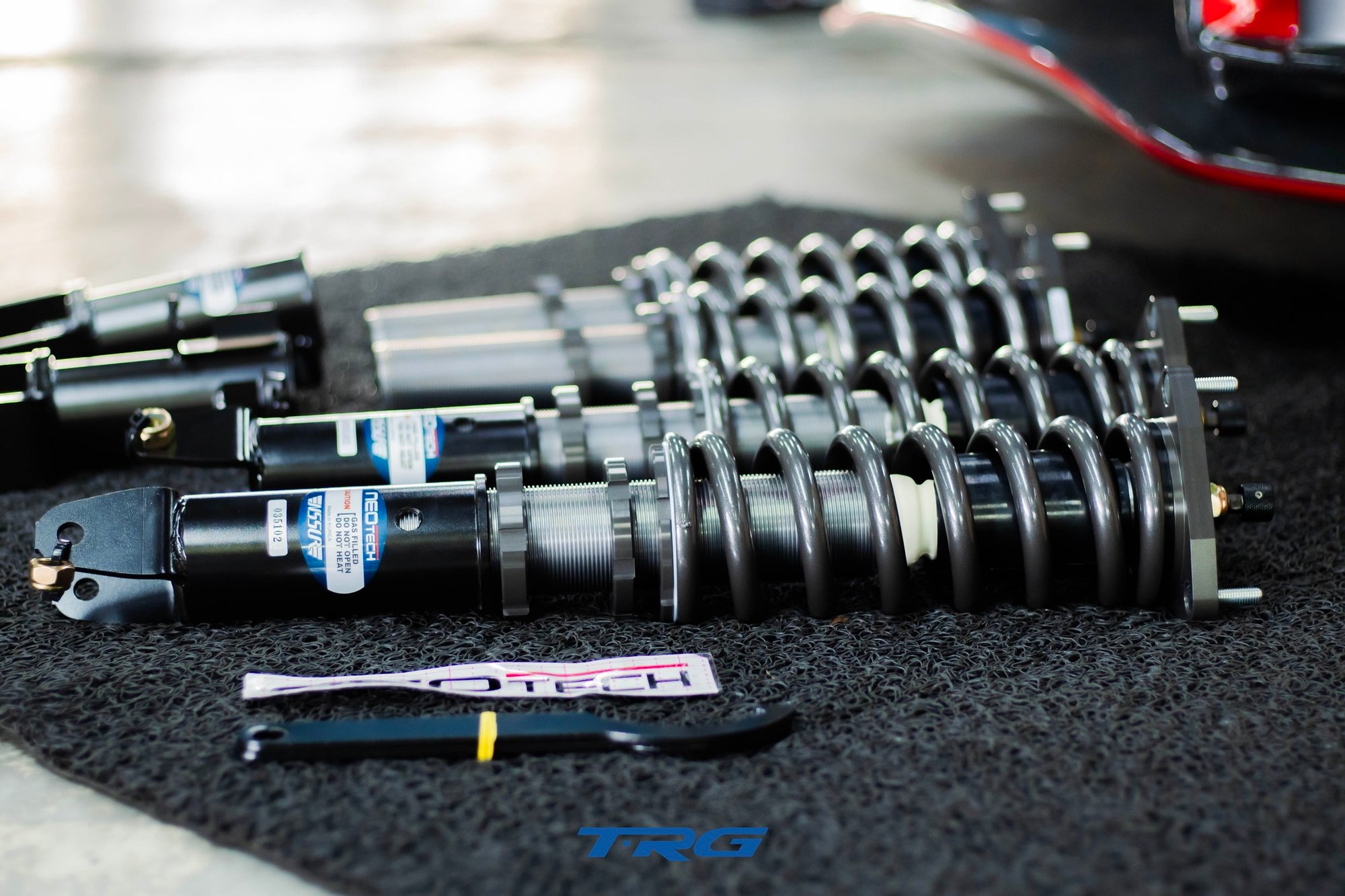 Low angle view of the assembled Neotech units with CAUTION GAS FILLED labels and the C spanner